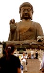 Tourists visiting The Big Buddha, with one man posing for a picture.